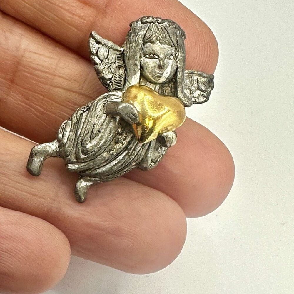 D.M. 95 silver tone angel holding gold tone  heart
